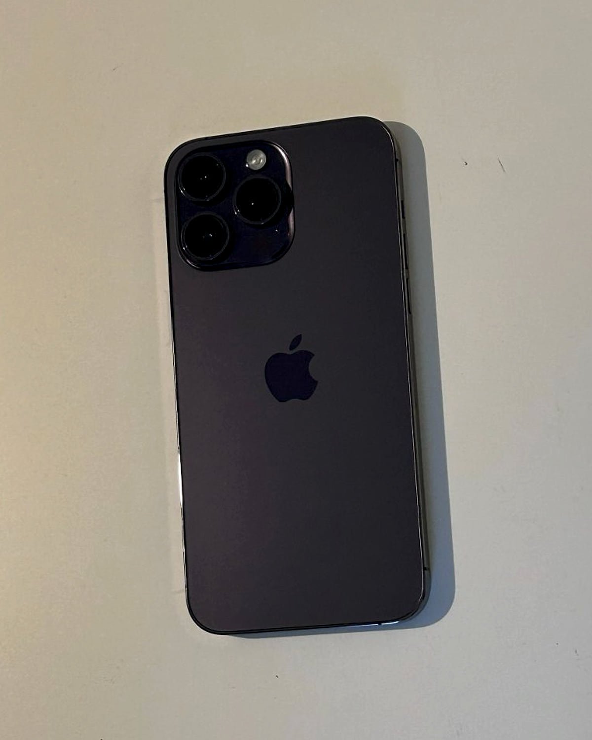 iPhone 14 Pro in deep purple on a desk