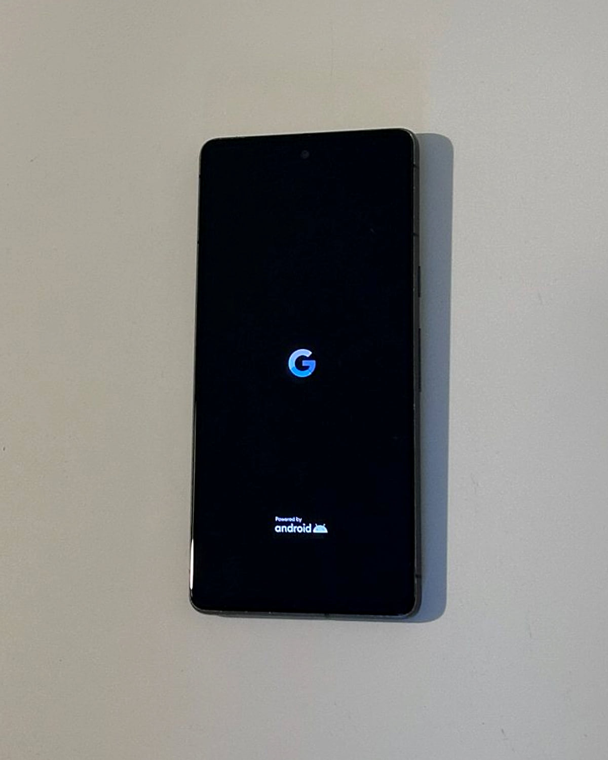 A Google Pixel on its boot screen, lying on a desk