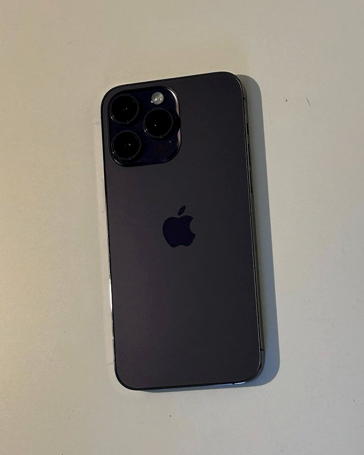 iPhone 14 Pro in deep purple on a desk